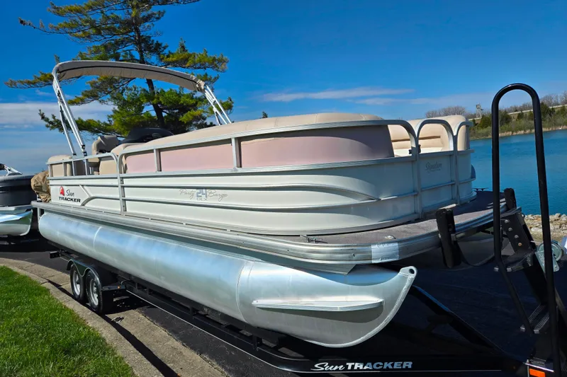Slide: The Image of 2016 Sun Tracker Party Barge 24 DLX pontoon boat on trailer by a lake. - 8