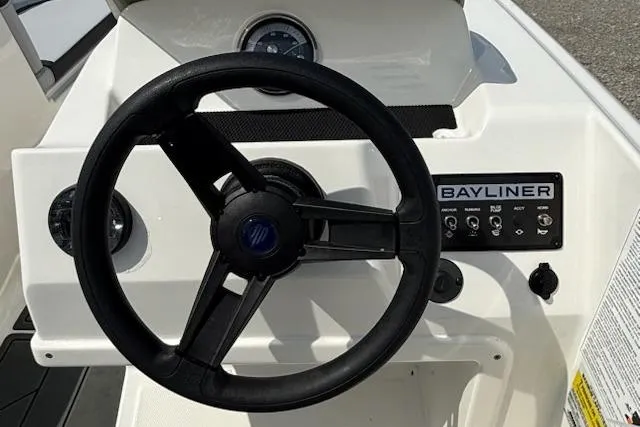 Slide: The Image of Steering wheel and dashboard of a 2026 Bayliner M17 boat. - 8