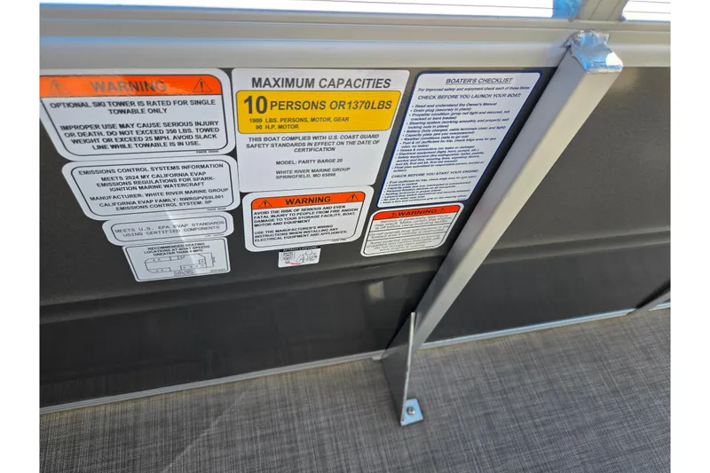 Slide: The Image of 2024 Sun Tracker Party Barge 20 DLX capacity and safety warning labels on interior panel. - 15