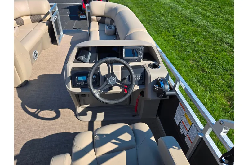 Slide: The Image of 2024 Sun Tracker Party Barge 20 DLX helm with steering wheel and control panel. - 20