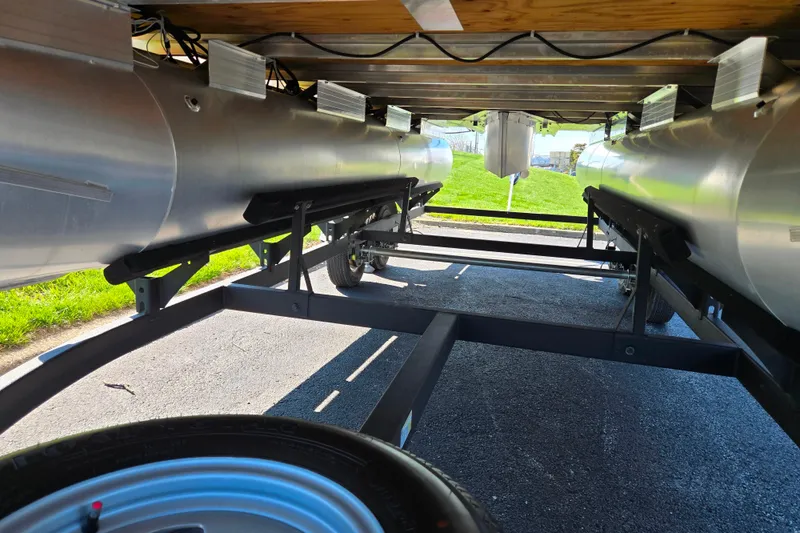 Slide: The Image of Underneath view of 2024 Sun Tracker Party Barge 20 DLX pontoon boat on trailer. - 7