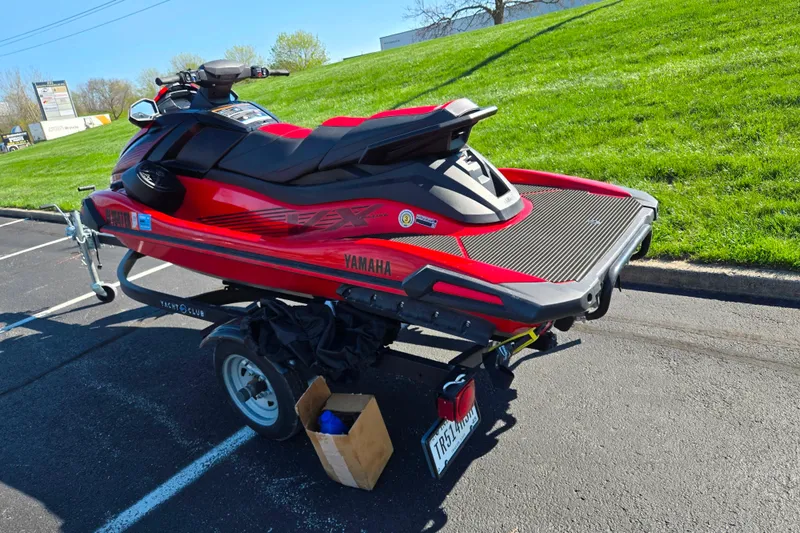 Slide: The Image of 2025 Yamaha WaveRunner VX Deluxe on trailer, parked on asphalt near grassy area. - 3