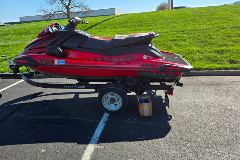 Slide: The Image of 2025 Yamaha WaveRunner VX Deluxe on trailer, parked on asphalt near grassy hill. - 4