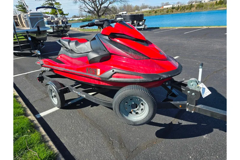 Slide: The Image of 2025 Yamaha WaveRunner VX Deluxe in red on a trailer by a lake. - 8