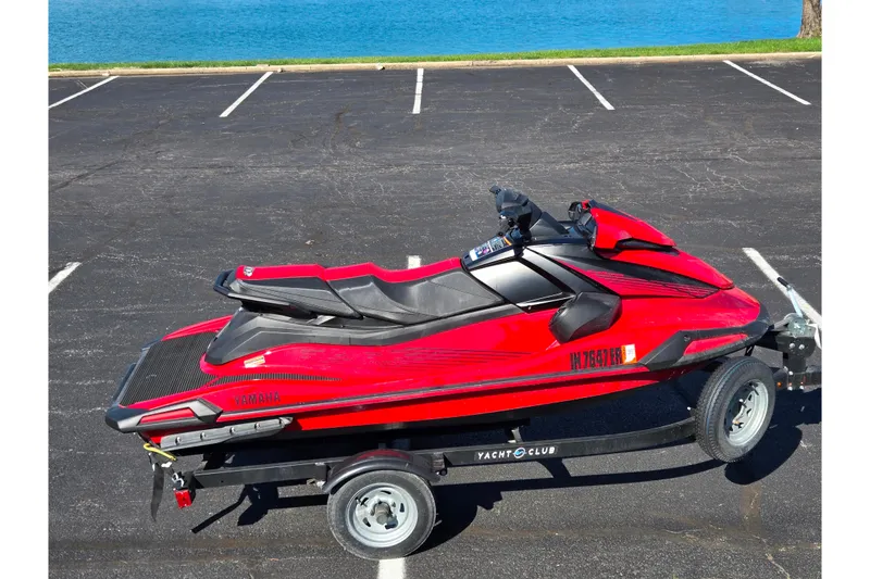 Slide: The Image of 2025 Yamaha WaveRunner VX Deluxe in red on a trailer by the water. - 9