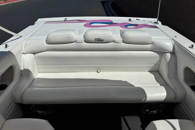Slide: The Image of White leather seating in a 1996 Warlock Ultimate boat with colorful design accents. - 16