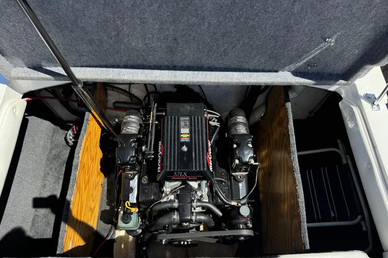 Slide: The Image of Engine compartment of a 1996 Warlock Ultimate boat, featuring a 5.7 LX MerCruiser engine. - 18
