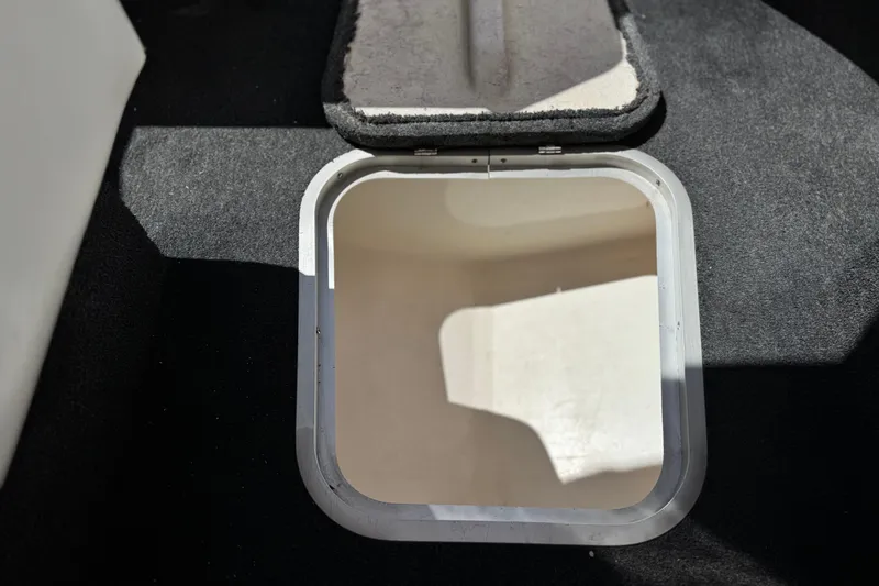 Slide: The Image of Open hatch on 1996 Warlock Ultimate boat, revealing interior storage space. - 27