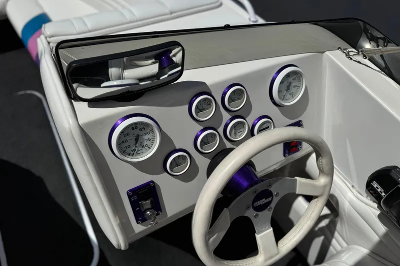 Slide: The Image of Dashboard of a 1996 Warlock Ultimate boat with gauges and steering wheel. - 30