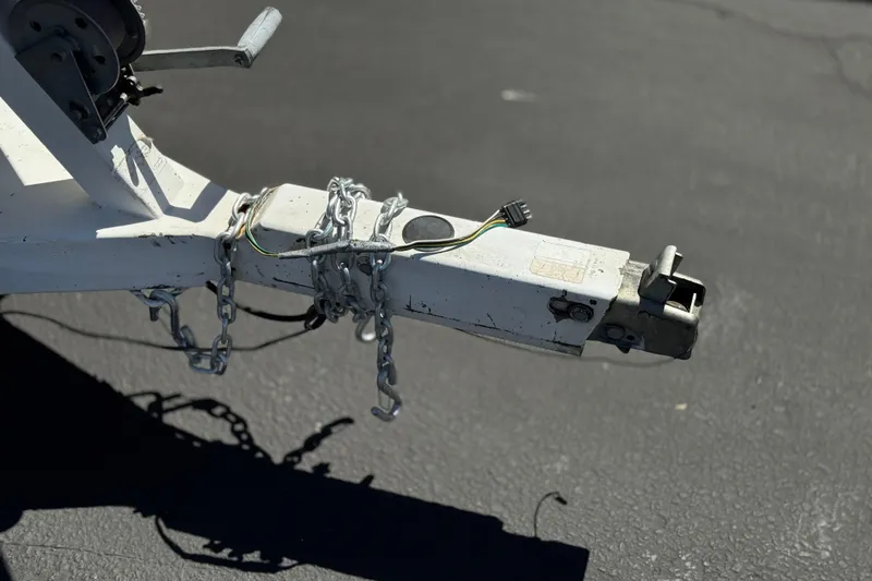 Slide: The Image of Trailer hitch with chains and wiring on a 1996 Warlock Ultimate. - 32