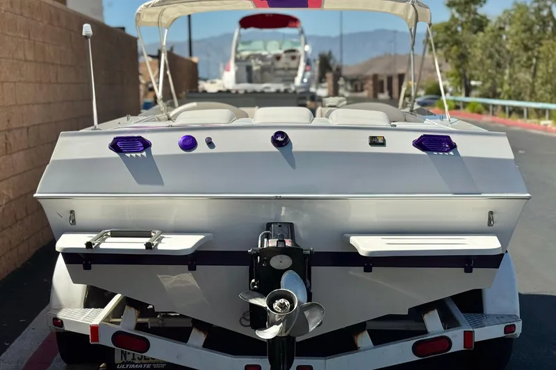 Slide: The Image of 1996 Warlock Ultimate boat on trailer, rear view with propeller and canopy. - 4