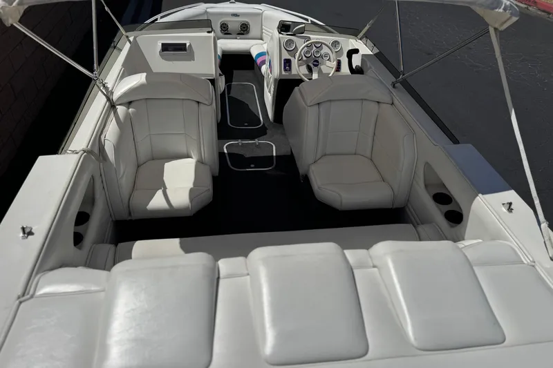 Slide: The Image of Interior of a 1996 Warlock Ultimate boat with white leather seating and modern dashboard. - 8
