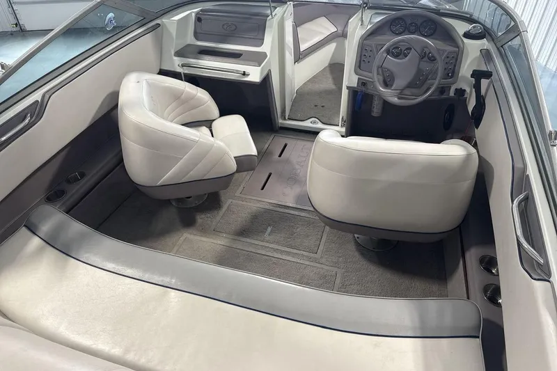 Slide: The Image of Interior of a 1997 Cobalt 200 boat with white seating and steering console. - 10