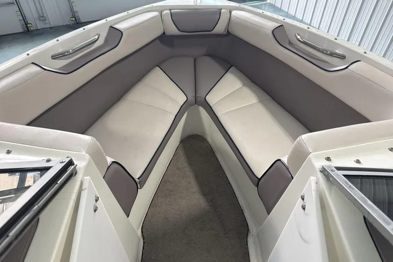 Slide: The Image of Interior of a 1997 Cobalt 200 boat with cushioned seating and carpeted floor. - 11