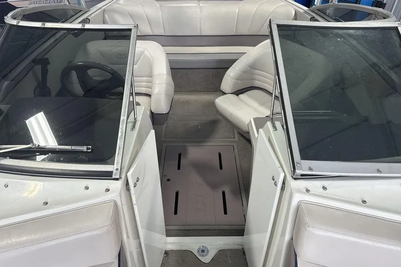 Slide: The Image of Interior of a 1997 Cobalt 200 boat with white seating and windshield. - 12