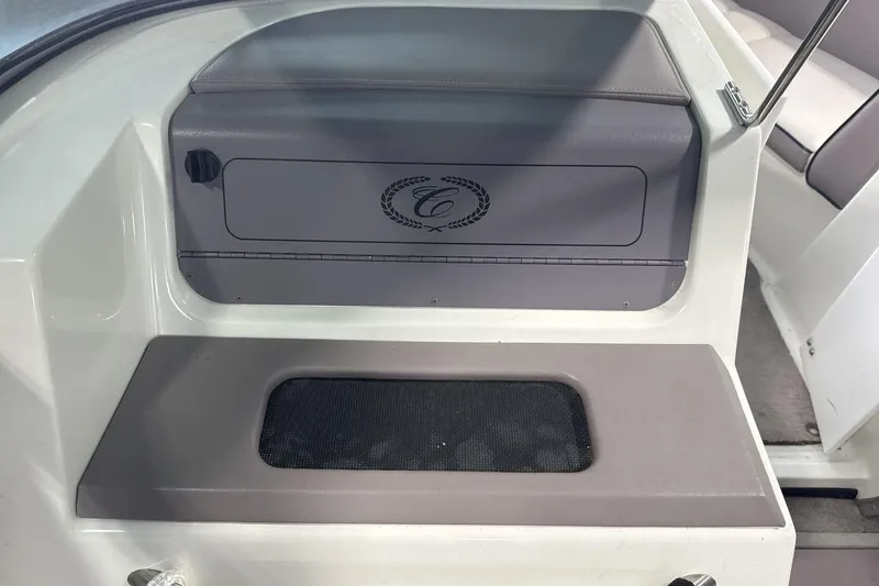 Slide: The Image of Interior of a 1997 Cobalt 200 boat, featuring a storage compartment with logo. - 18