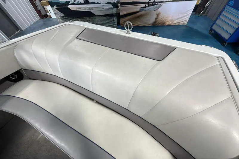 Slide: The Image of 1997 Cobalt 200 boat interior with white and gray seating in a showroom. - 19