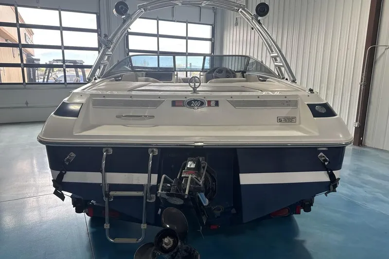 Slide: The Image of 1997 Cobalt 200 boat in a garage, showcasing rear view and propeller. - 5