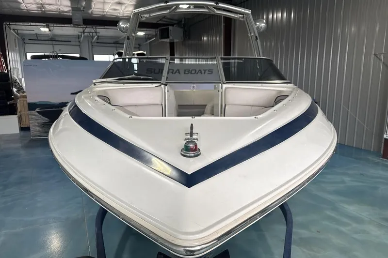 Slide: The Image of 1997 Cobalt 200 boat in showroom, featuring sleek design and white-blue color scheme. - 8