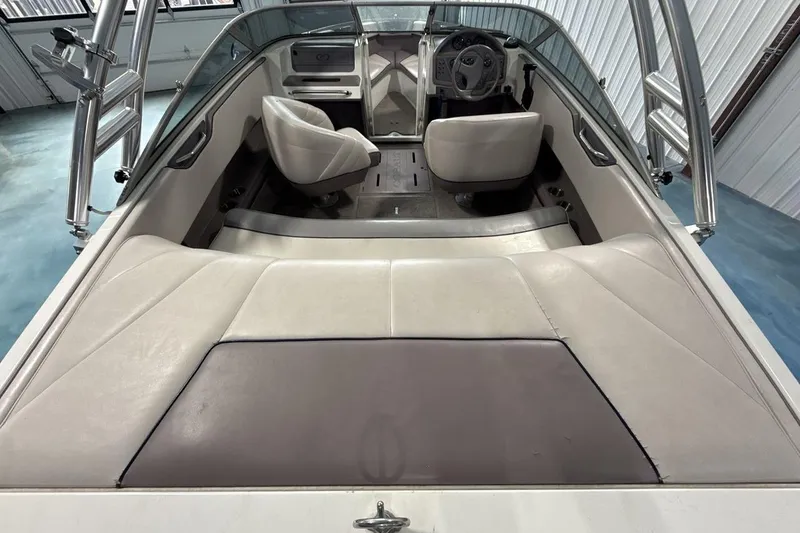 Slide: The Image of Interior of a 1997 Cobalt 200 boat with white seating and steering wheel. - 9