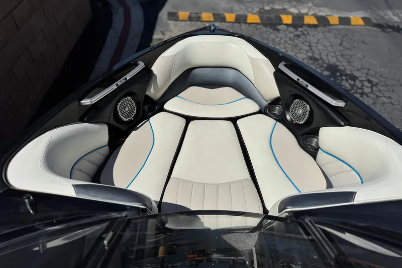 Slide: The Image of 2015 Malibu Wakesetter 247 LSV boat interior with white seating and speakers. - 13