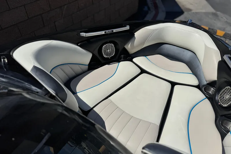 Slide: The Image of 2015 Malibu Wakesetter 247 LSV boat interior with white and blue seating. - 14