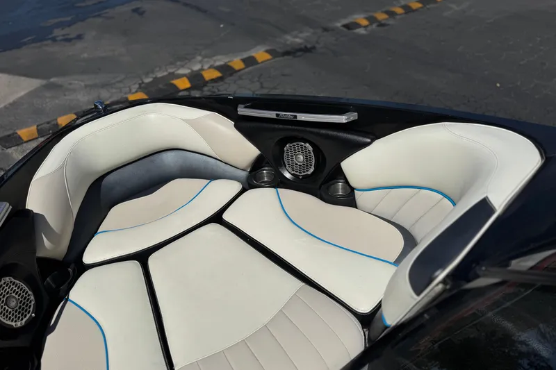 Slide: The Image of 2015 Malibu Wakesetter 247 LSV boat interior with white seating and speakers. - 15