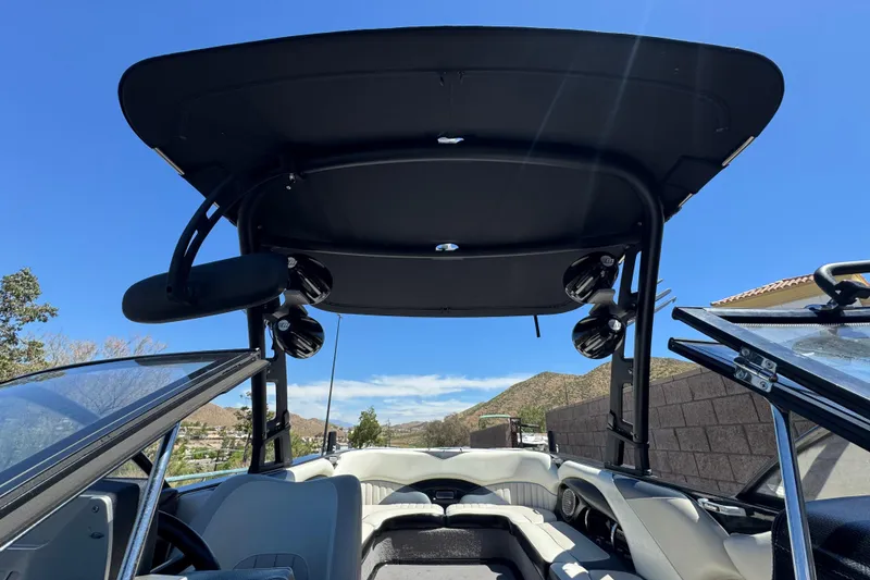 Slide: The Image of 2015 Malibu Wakesetter 247 LSV interior with speakers and open canopy under blue sky. - 17