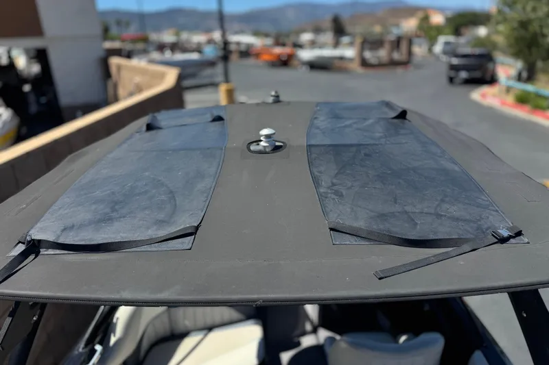 Slide: The Image of 2015 Malibu Wakesetter 247 LSV boat roof with black cover in outdoor setting. - 18