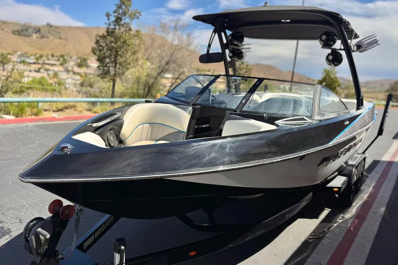 Slide: The Image of 2015 Malibu Wakesetter 247 LSV boat on trailer, parked outdoors. - 3