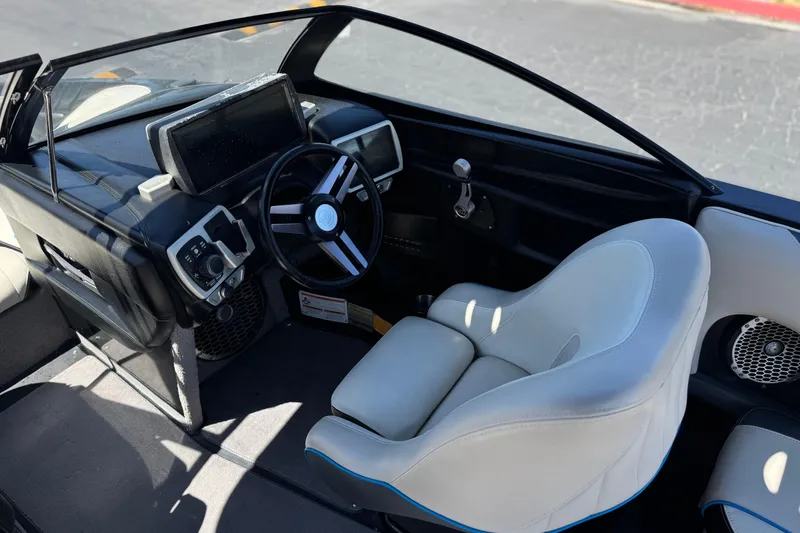 Slide: The Image of 2015 Malibu Wakesetter 247 LSV boat interior with steering wheel and dashboard controls. - 32
