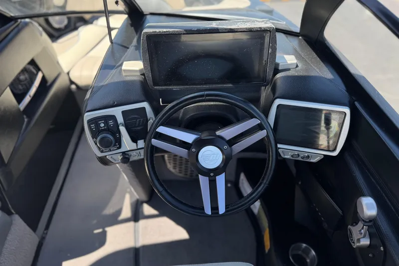 Slide: The Image of 2015 Malibu Wakesetter 247 LSV dashboard with steering wheel and digital displays. - 33