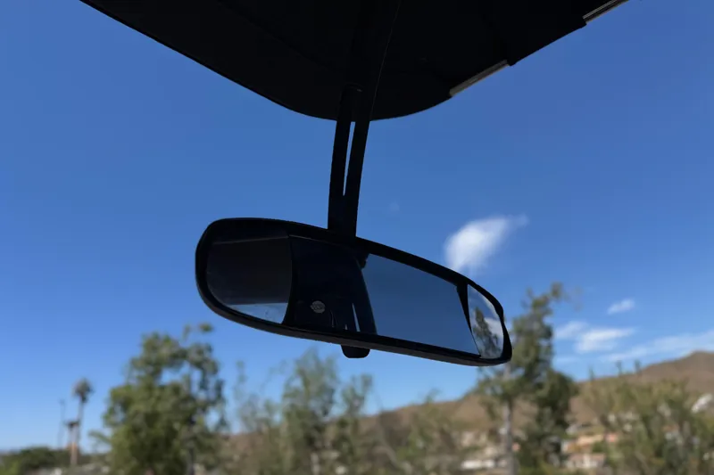 Slide: The Image of Rearview mirror of 2015 Malibu Wakesetter 247 LSV against clear blue sky. - 35