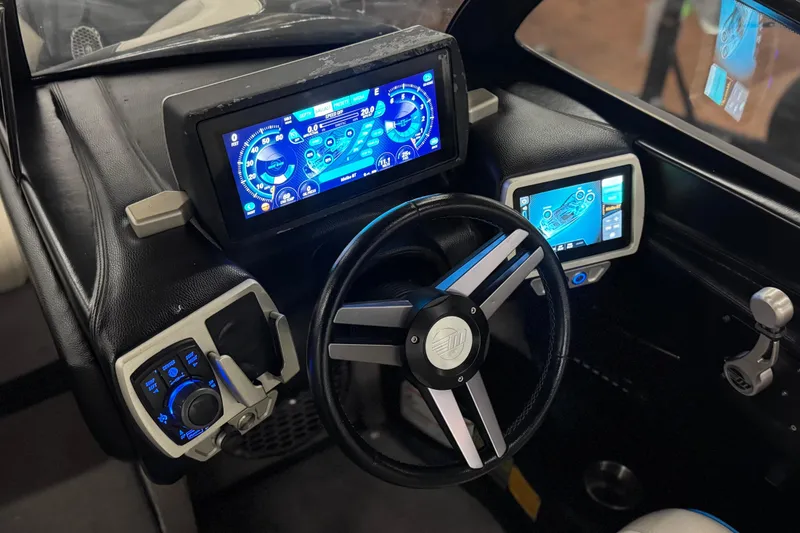 Slide: The Image of 2015 Malibu Wakesetter 247 LSV dashboard with digital displays and steering wheel. - 36