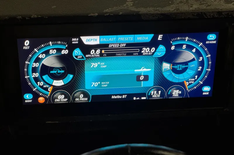Slide: The Image of Dashboard display of a 2015 Malibu Wakesetter 247 LSV boat showing speed and temperature. - 38