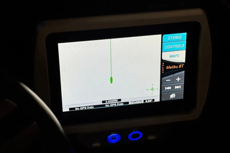 Slide: The Image of Dashboard display of a 2015 Malibu Wakesetter 247 LSV boat with navigation controls. - 39