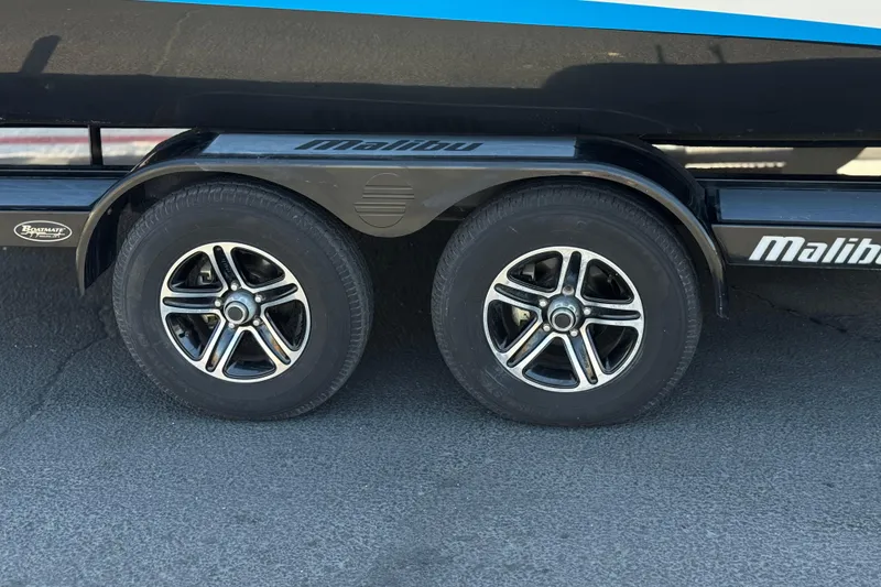 Slide: The Image of Trailer wheels of a 2015 Malibu Wakesetter 247 LSV boat on pavement. - 43