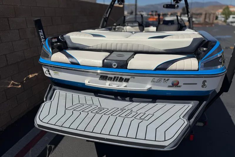 Slide: The Image of 2015 Malibu Wakesetter 247 LSV boat, rear view with swim platform and seating. - 6