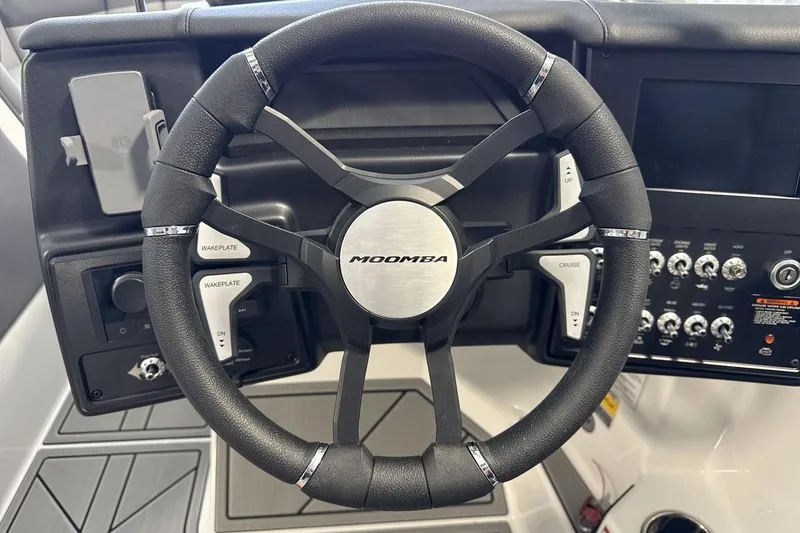 Slide: The Image of Steering wheel of 2026 Moomba Max boat with control panel and buttons. - 14
