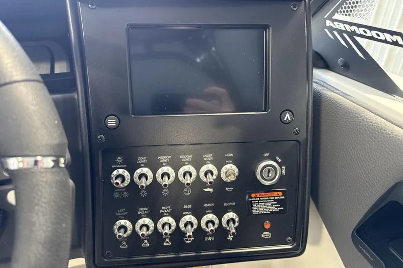 Slide: The Image of Control panel of 2026 Moomba Max boat with switches and display screen. - 15