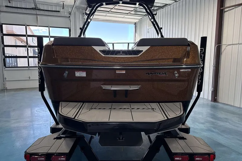 Slide: The Image of 2026 Moomba Max boat in a garage, showcasing rear design and Raptor engine. - 4