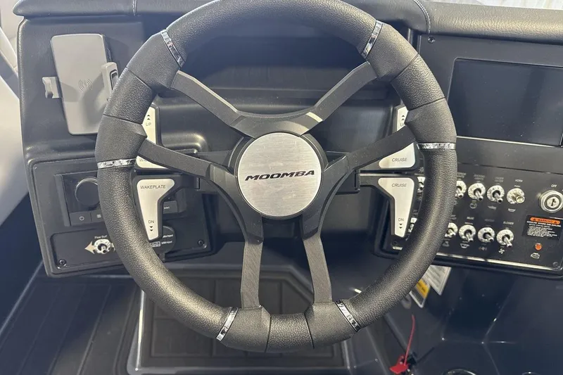 Slide: The Image of Steering wheel of 2026 Moomba Tykon boat with control panel and buttons. - 14