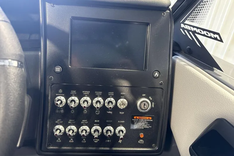 Slide: The Image of Control panel of 2026 Moomba Tykon boat with switches and display screen. - 15