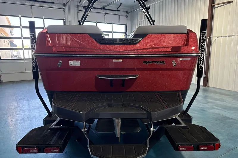 Slide: The Image of 2026 Moomba Tykon boat rear view in a garage, featuring Raptor engine branding. - 5