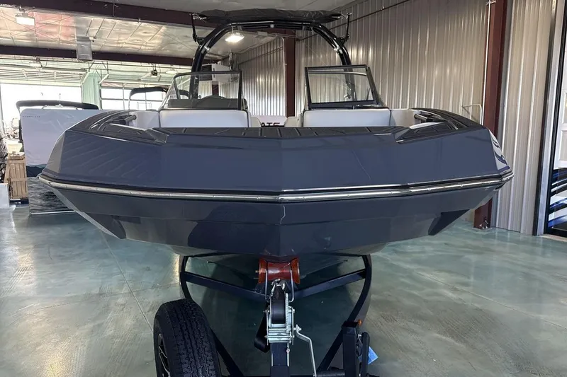 Slide: The Image of 2026 Moomba Tykon boat in showroom, sleek design, on trailer. - 8