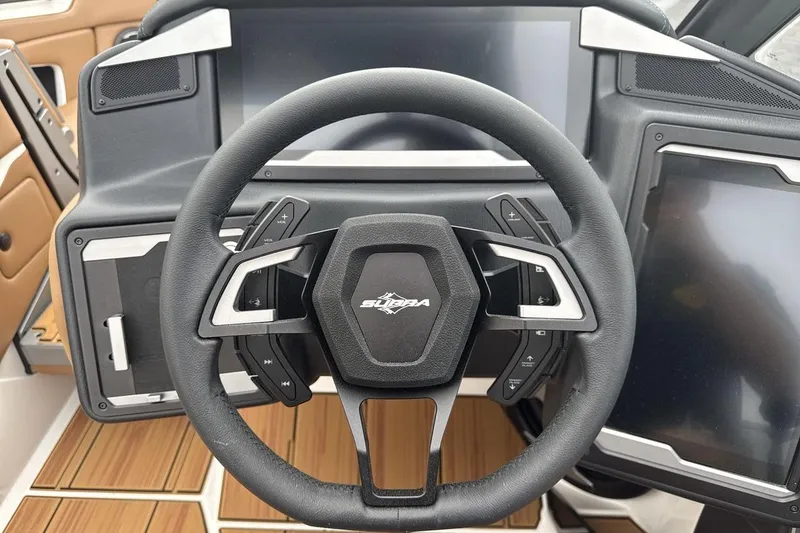 Slide: The Image of Steering wheel of a 2026 Supra SV boat with modern dashboard controls. - 14