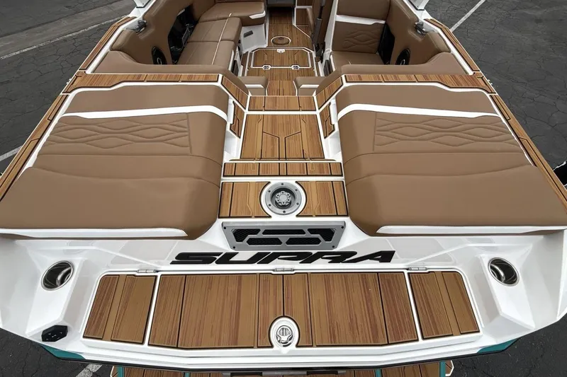 Slide: The Image of 2026 Supra SV boat interior with tan seating and wood accents. - 19