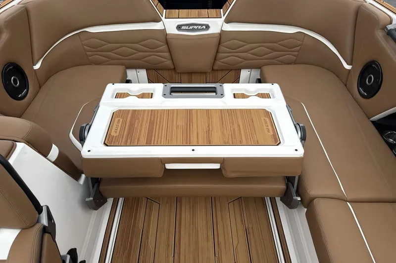 Slide: The Image of Luxurious interior of 2026 Supra SV boat with tan seating and wood accents. - 23