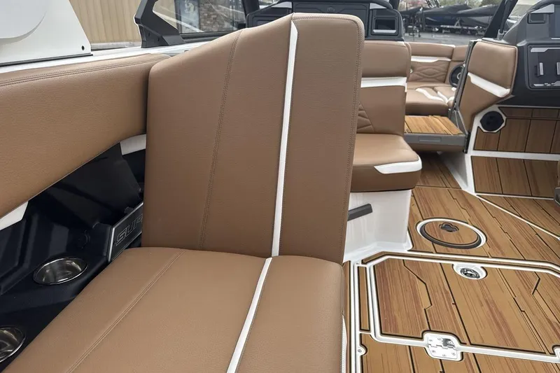 Slide: The Image of 2026 Supra SV boat interior with brown leather seats and wood-style flooring. - 25