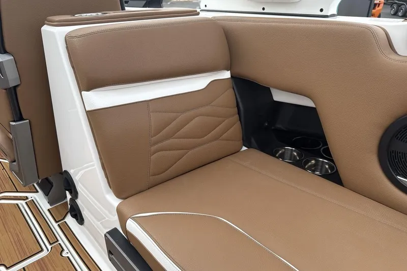 Slide: The Image of 2026 Supra SV interior with brown leather seating and cup holders. - 26